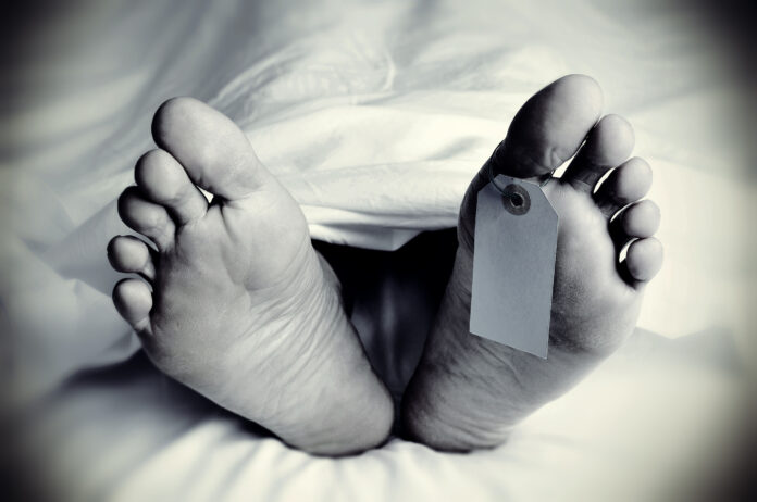 dead body with a blank toe tag, in monochrome Svg%3E